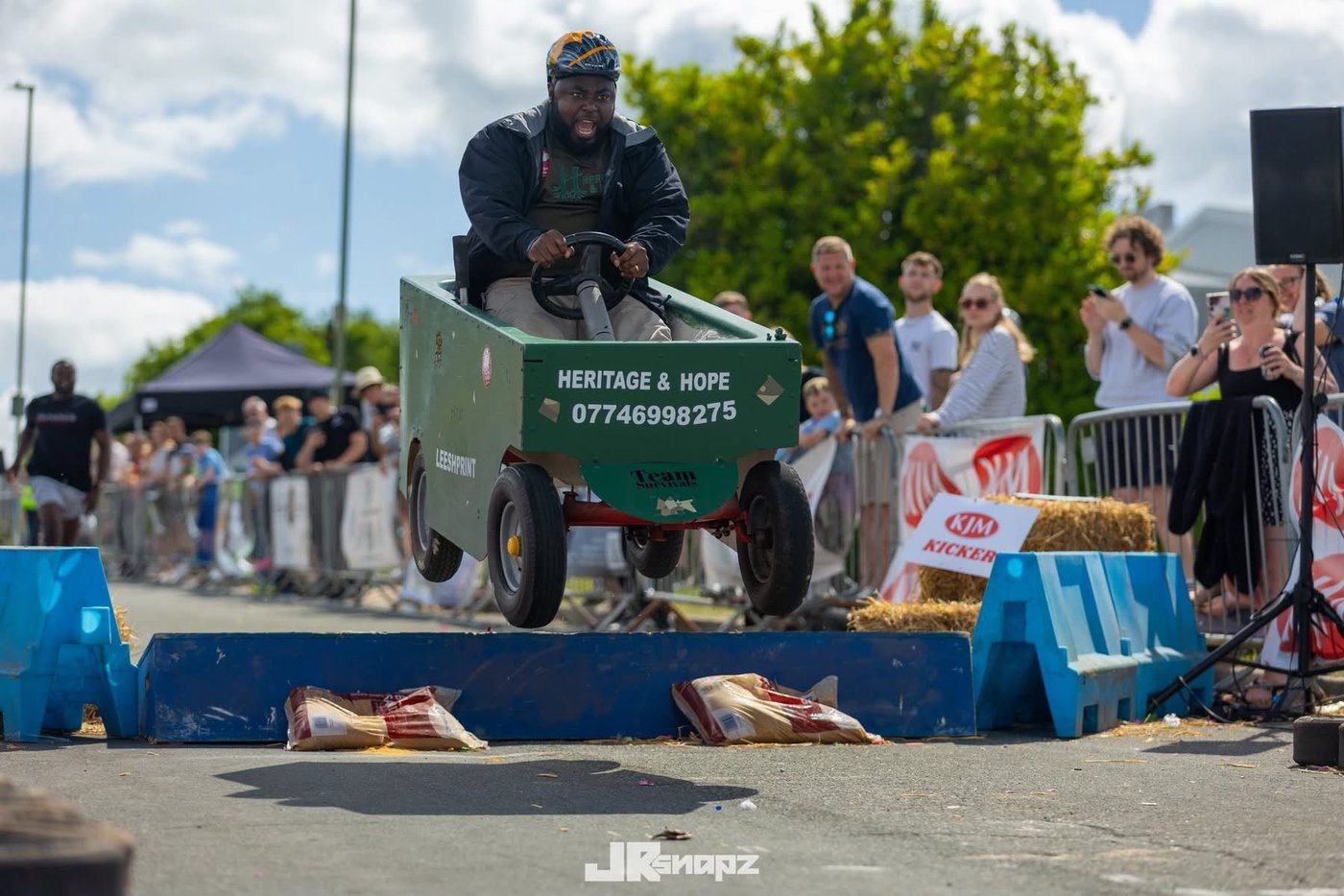 Heritage & Hope soapbox cart at a community race with spectators cheering